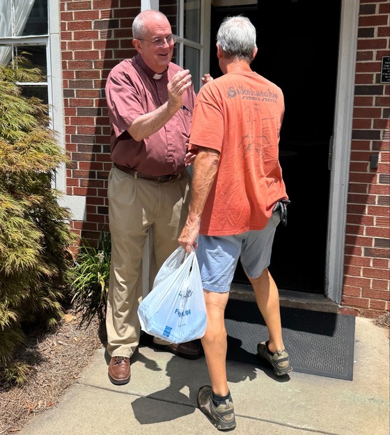 pastor Bowling giving food-1-1